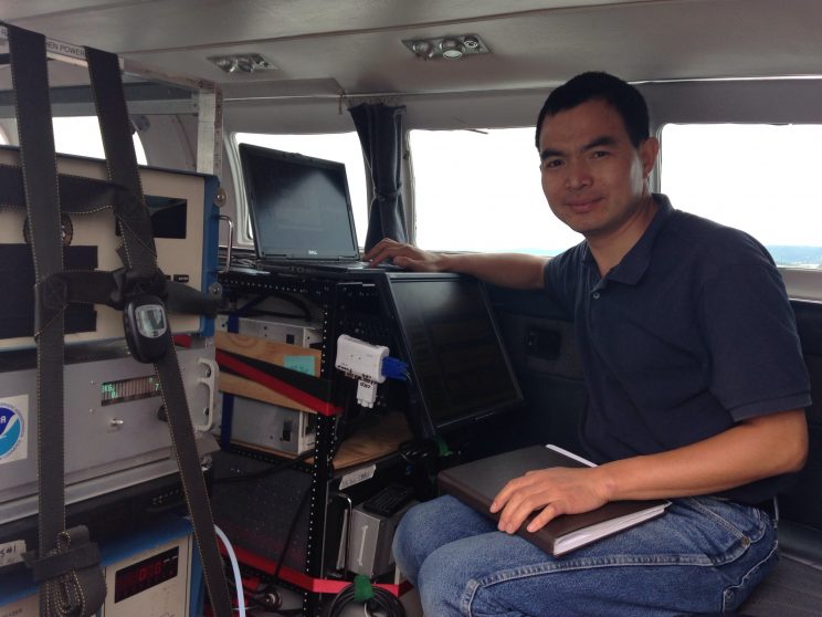 Dr. Ren in the plane's cabin with the equipment (computer and analyzers).