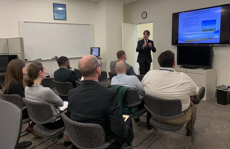 Dr. Stein presenting ARL 101 to a group of seven people