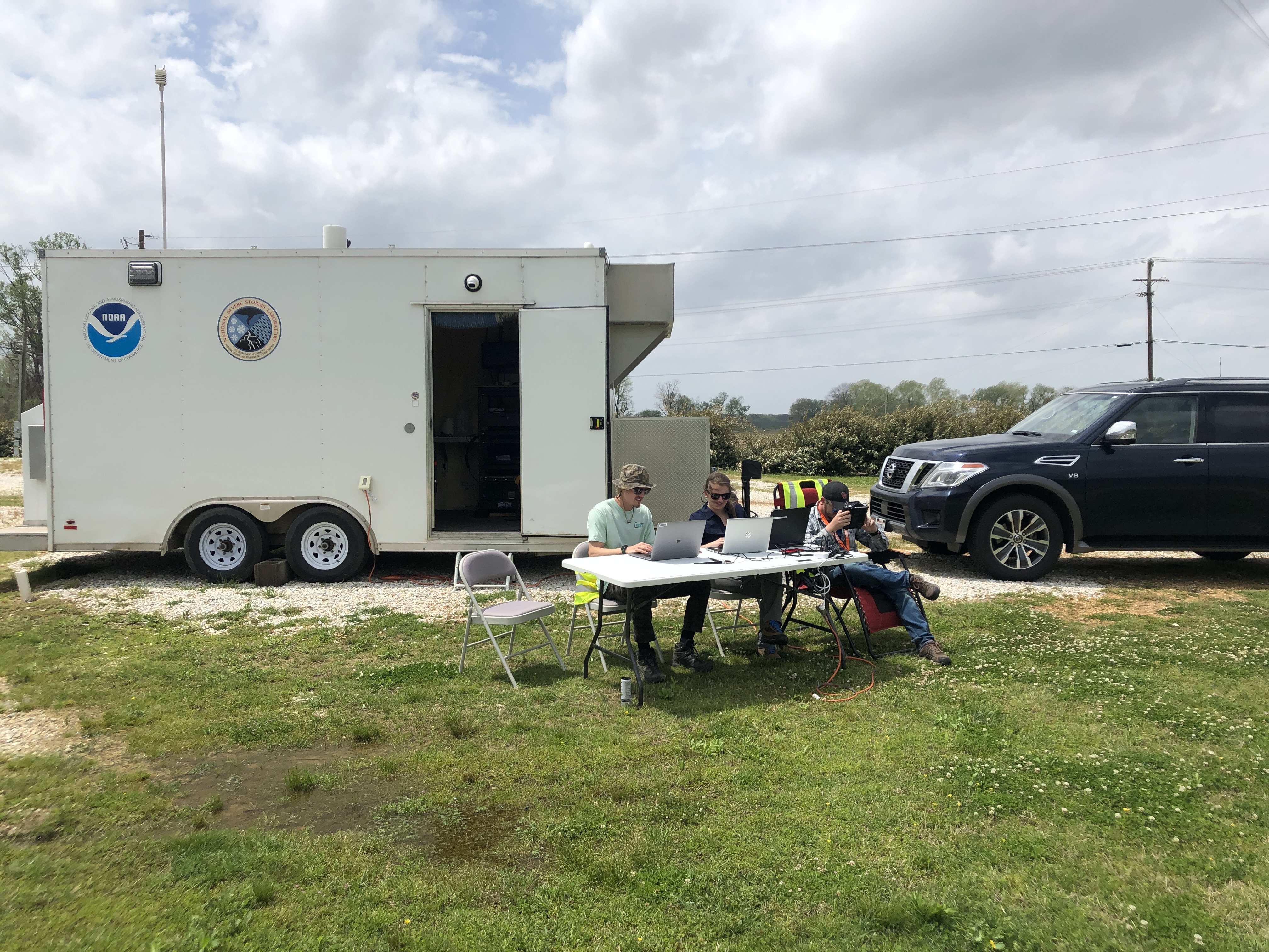 NOAA Equipment trailer with people working outside.