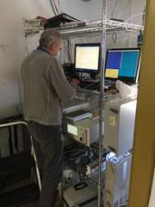 Interior view of equipment racks with person standing.