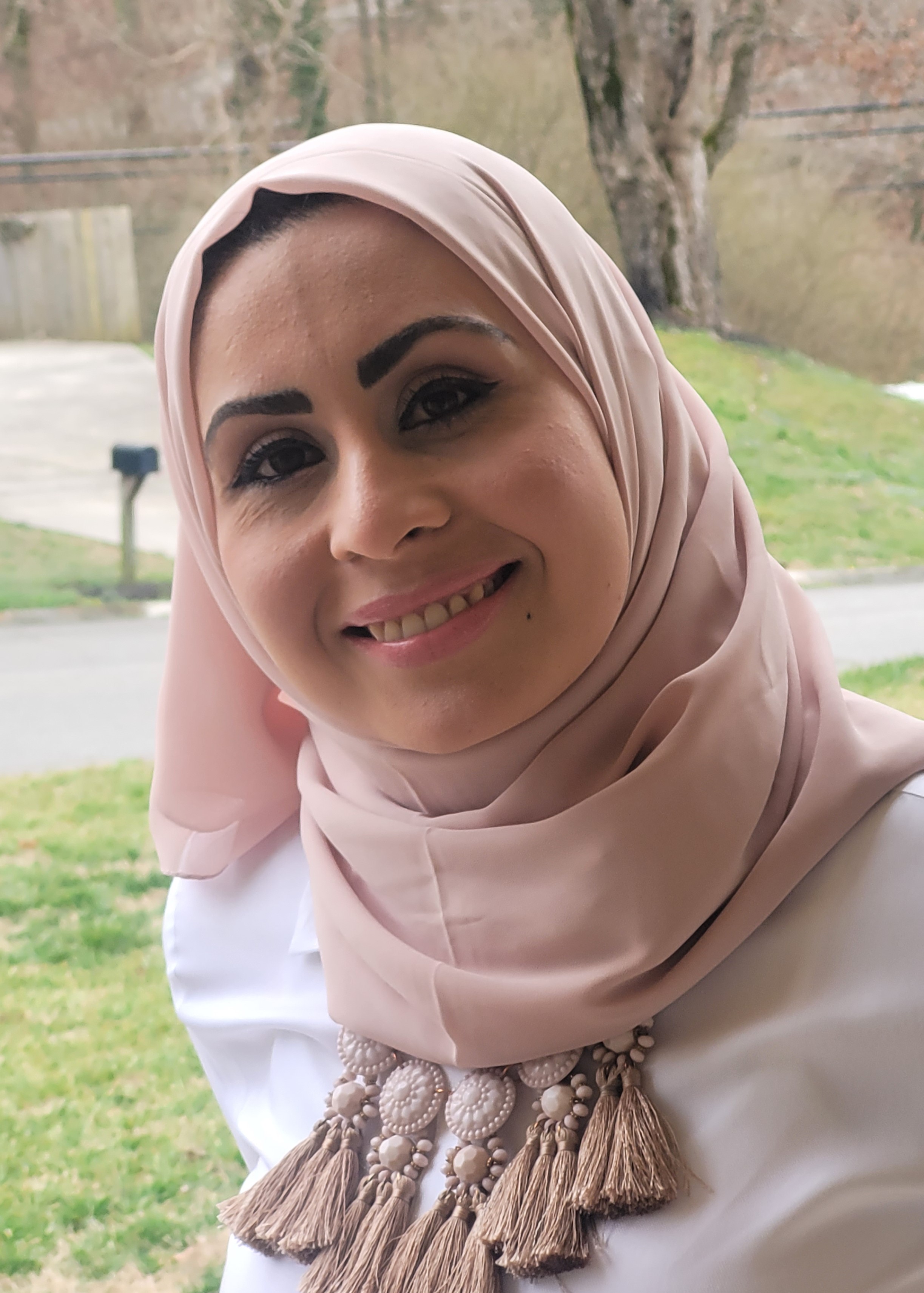 Picture of a smiling woman wearing a headscarf