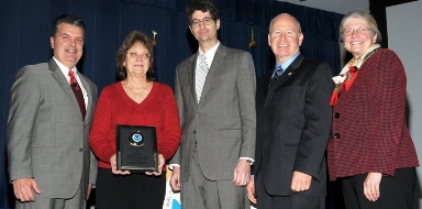 Betty Wells receiving her OAR Employee of the Year Award from Craig McLean