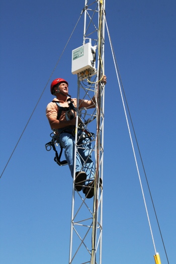 ARL scientist installing equipment on tower for California air study. Photo Credit: NOAA, May 2010